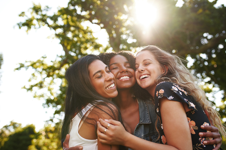 A group of young girls embracing.